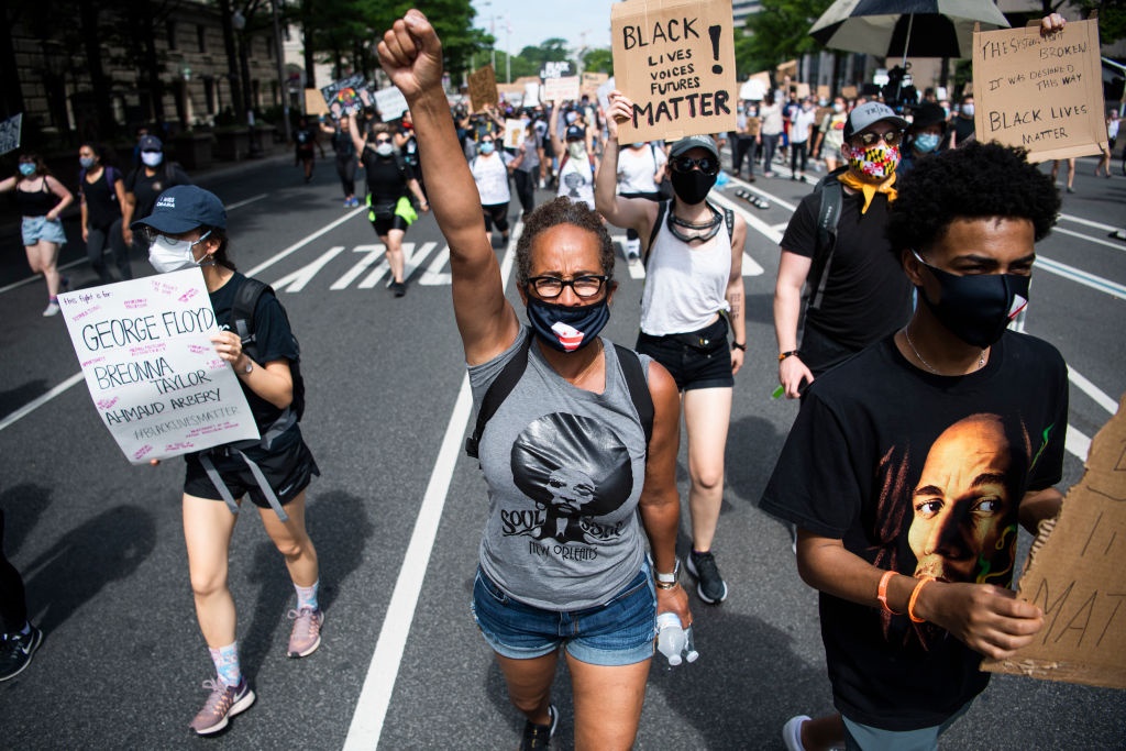 Demonstrators march in protest of the death of George Floyd.