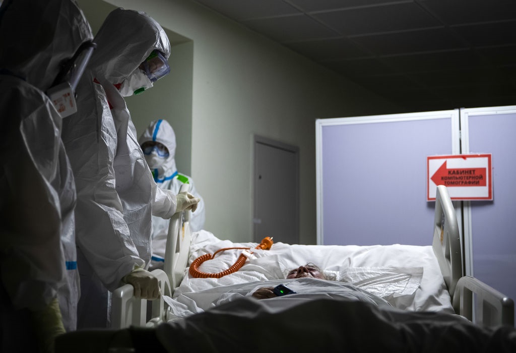 Medical workers attend to a patient in Russia. 