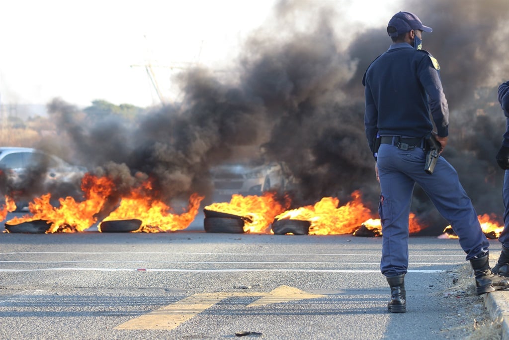 Police stand by at a protest in KZN