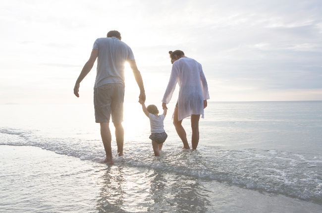 Family walking at the beach. (PHOTO: Jasper James/Getty Images)