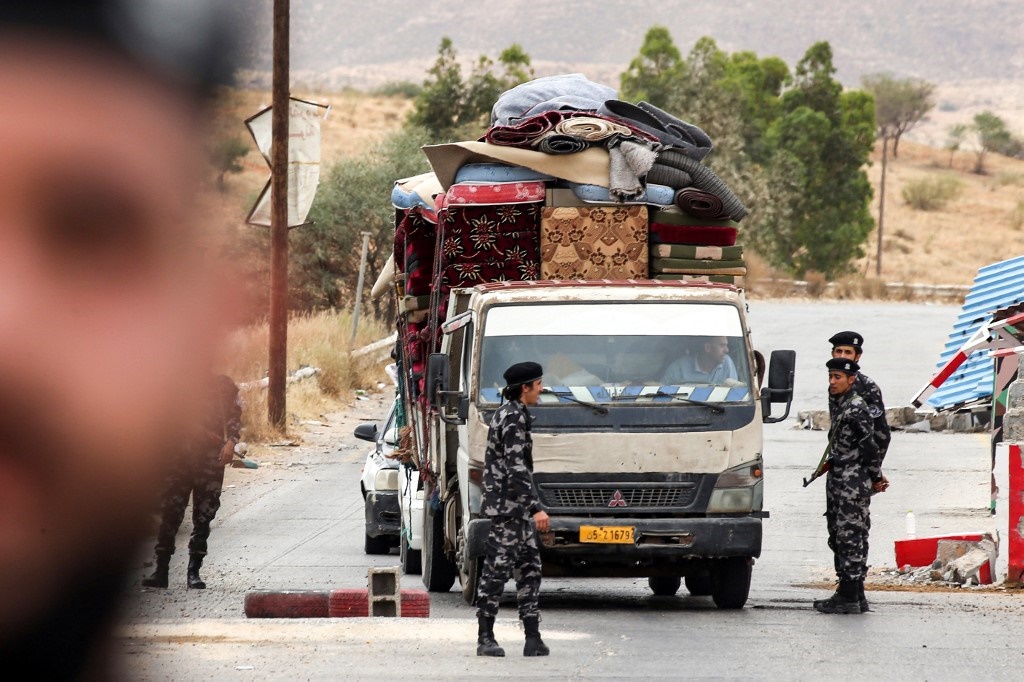 Members of security forces affiliated with the Libyan Government of National Accord (GNA)'s Interior Ministry stop a vehicle at a checkpoint in the town of Tarhuna, about 65 kilometres southeast of the capital Tripoli.