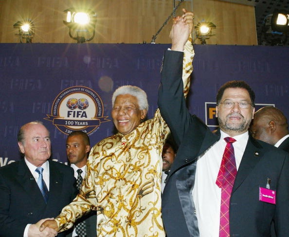  Former South African President Nelson Mandelas hand is held high by Danny Jordaan and  former Fifa President Sepp Blatter during the FIFA 2010 World Cup Host Announcement at the World Trade Centre on May 15, 2004 in Zurich, Switzerland.  (Photo by Touchline/Getty Images)