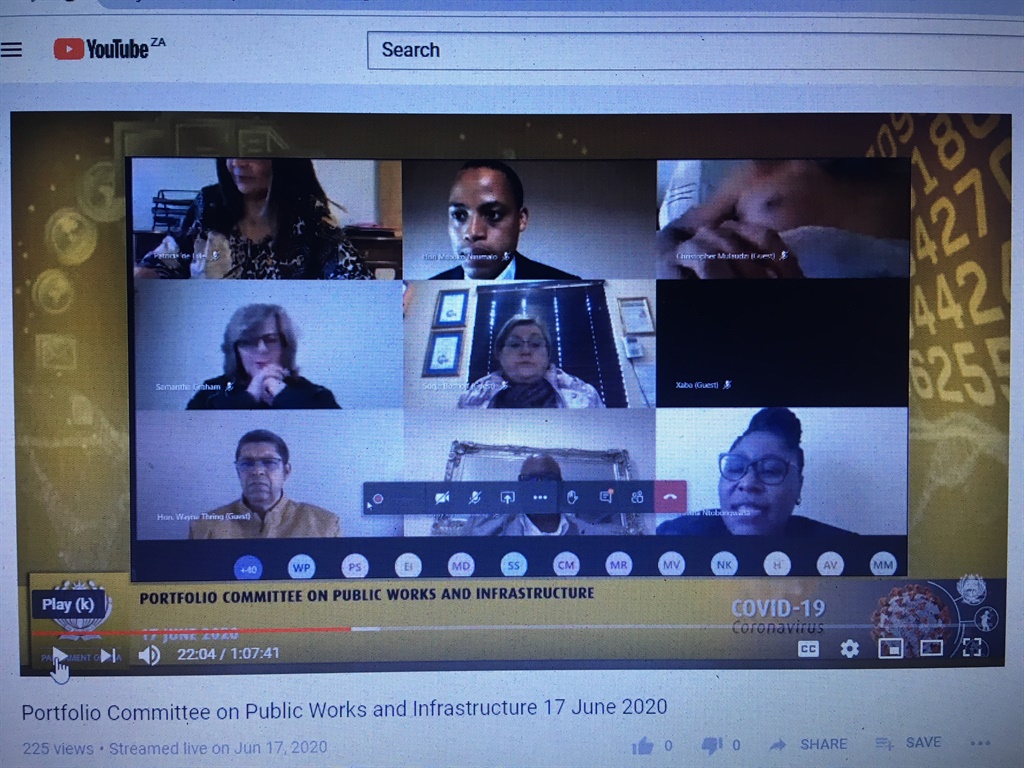 An official of the Independent Development Trust, with the screen name Christopher Mulaudzi, attends a parliamentary meeting without his shirt on, in the top right hand corner. 