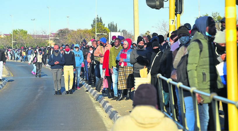 Hundreds of stranded taxi commuters flocked to the Rea Vaya Bus station as they couldn't get taxis to their respective destinations. (Photo by Christopher Moagi)