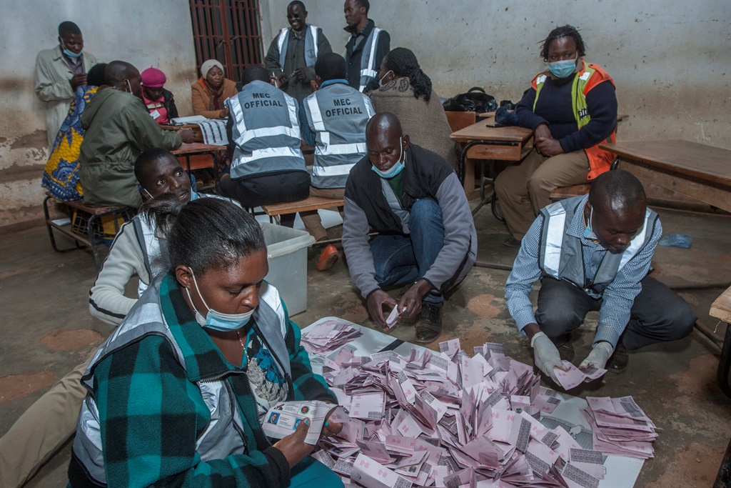 Electoral officials and political party monitors count votes at the Mighty Caspia polling station in Area 23, a residential location in Lilongwe.