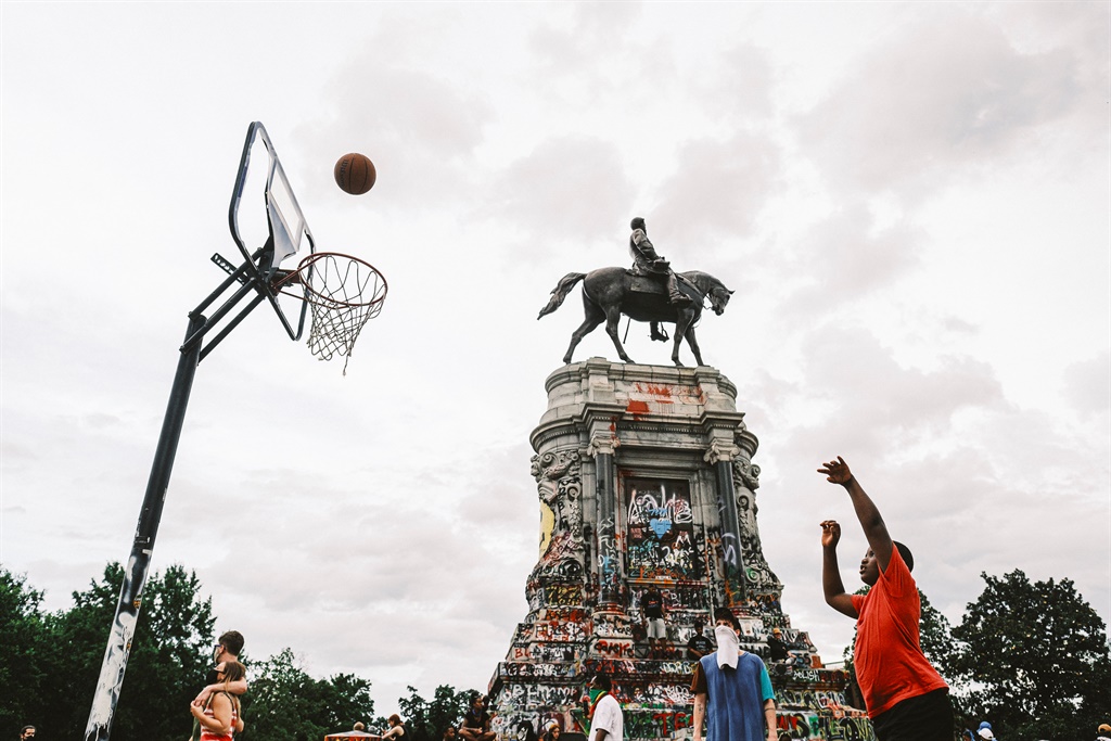 RICHMOND, VA - JUNE 23: A boy plays basketball nea