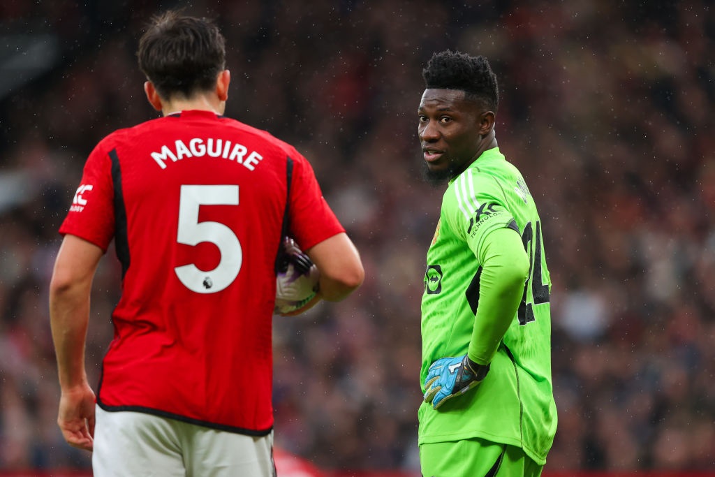 MANCHESTER, ENGLAND - FEBRUARY 24: Andre Onana of Manchester United speaks with teammate Harry Maguire during the Premier League match between Manchester United and Fulham FC at Old Trafford on February 24, 2024 in Manchester, England. (Photo by James Gill - Danehouse/Getty Images)
