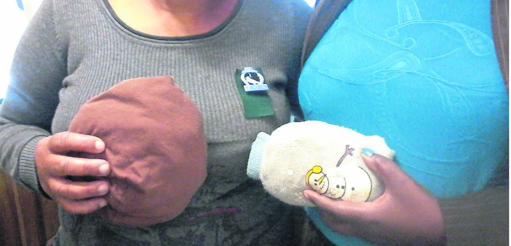 Recipients hold silicone breast prostheses which are wrapped up for safekeeping.