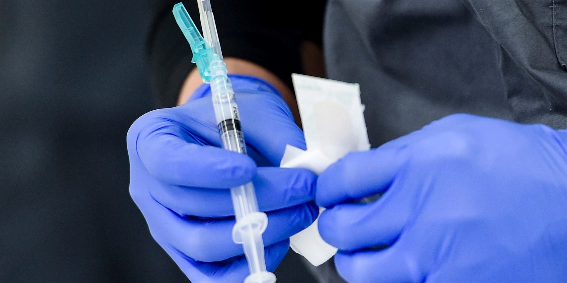 A healthcare worker holds a syringe of Covid-19 vaccine. 