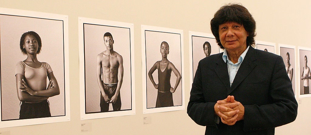 George Hallett poses in front of some of his work exhibited at the Iziko Art Gallery on November 25, 2001 (Photo by Foto24/Gallo Images/Getty Images)