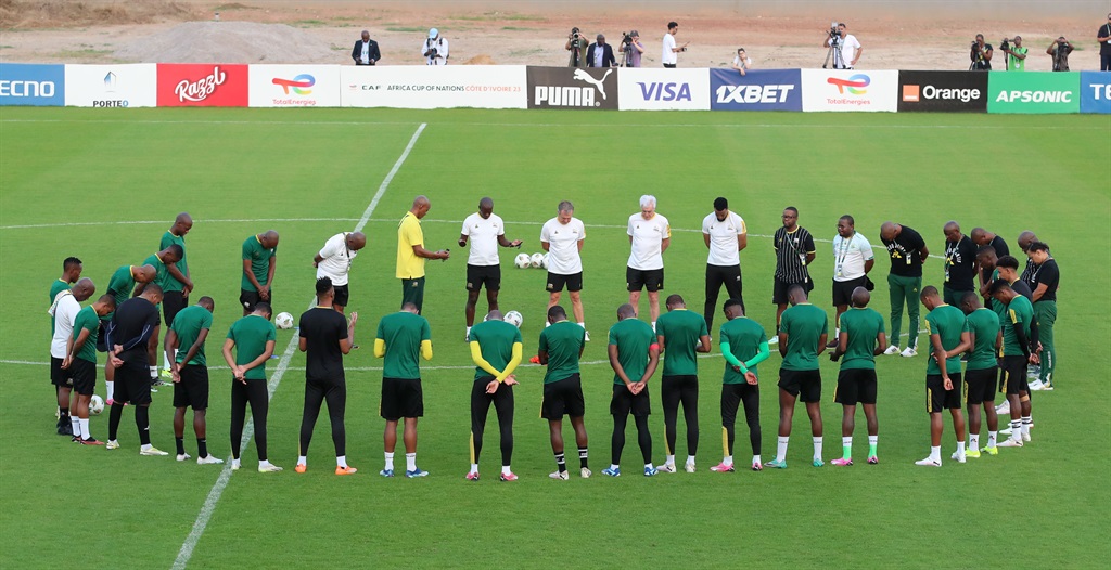 Bafana Bafana players pray before warming up for a training session at the Auguste Denis East Stadium in San Pedro, Ivory Coast.