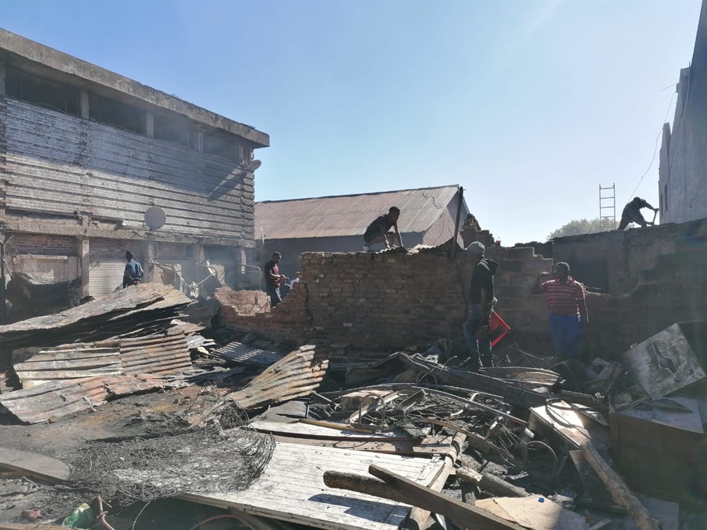 Men try and rebuild their homes using debris that 