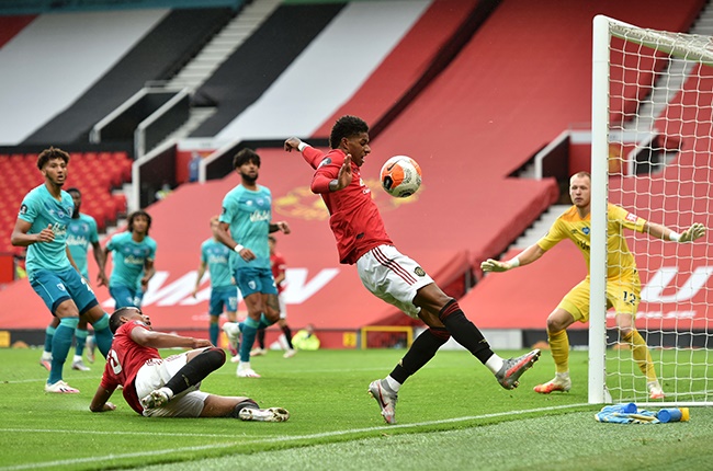Anthony Martial and Marcus Rashford of Manchester United chase the ball during the Premier League match against Bournemouth at Old Trafford on 4 July 2020. 