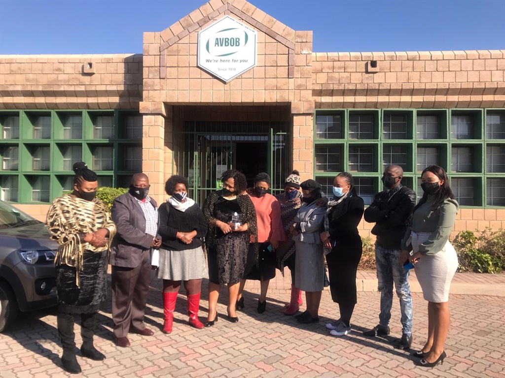 Lulamile Ngqezana's family standing outside the Av