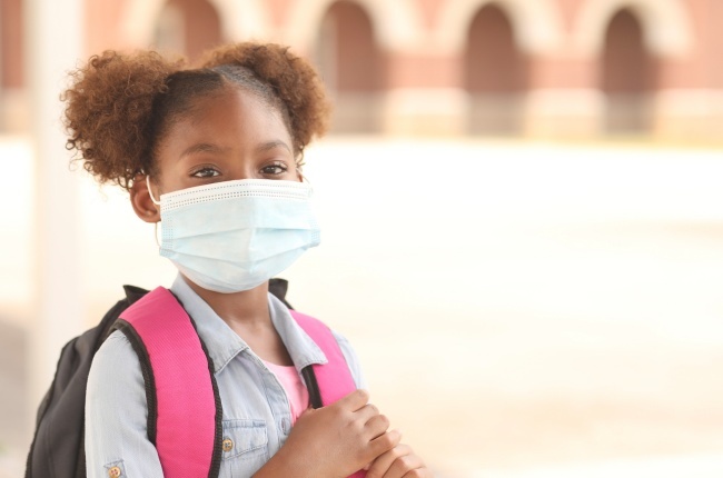 A girl wears a mask to school to help protect her against Covid-19.