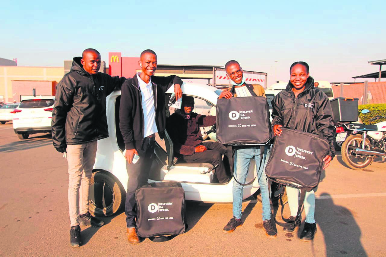 Godiragetse Mogajane (second from left) owns Delivery Ka Speed, that delivers food around the Hammanskraal area.                Photo by Raymond Morare