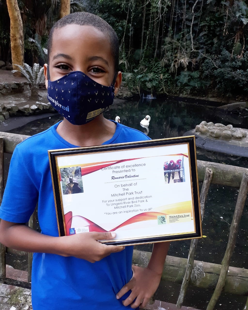 A proud Romario Valentine with his certificate of 