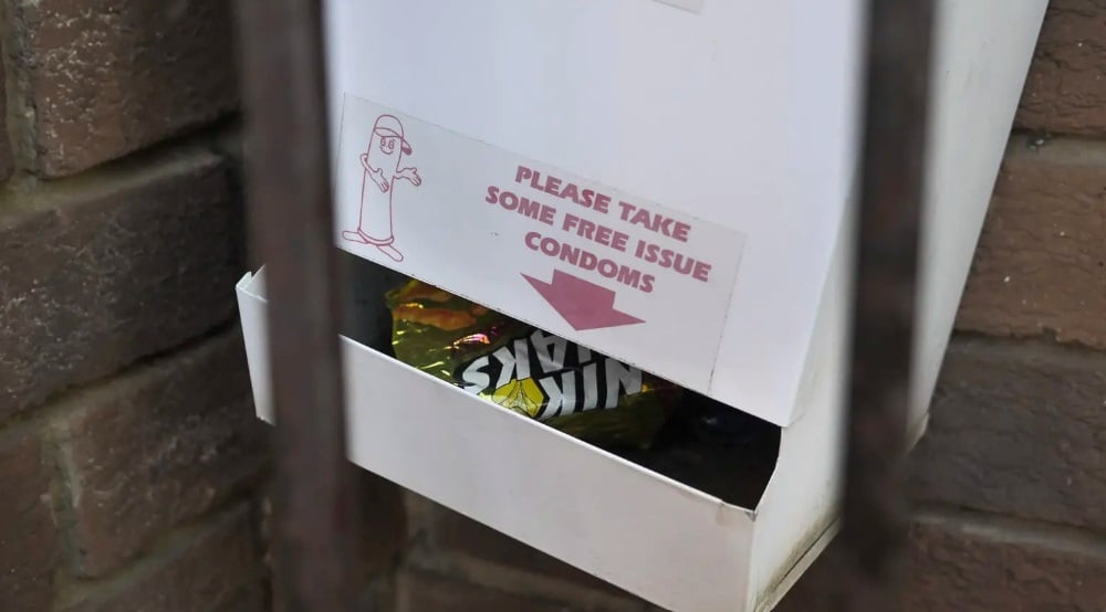 An empty condom dispenser seen with a Nik Naks wrapper inside at one of the clinics monitored by Ritshidze. (Rian Horn/Ritshidze)