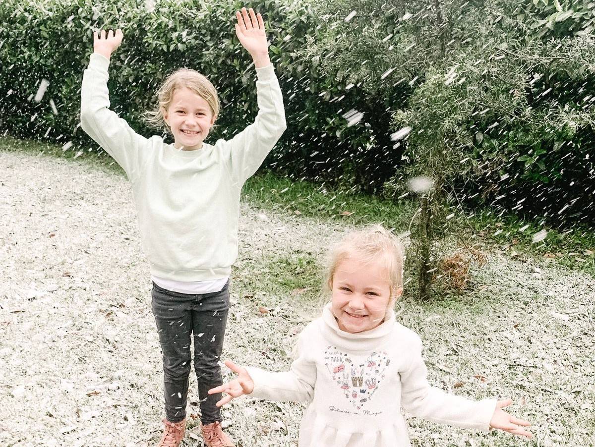 Sasha (9) and Lilah (4) Smith play in snow in Botha’s Hill, near Hillcrest.PHOTO: Supplied