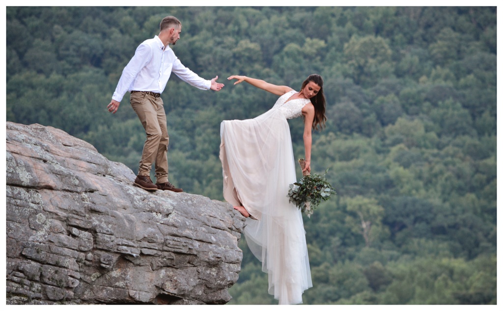 Newly weds, Ryan and Skye Myers took their wedding pictures on the edge of a cliff. Photo by Mason Gardner/ Caters News/ Magazine Features