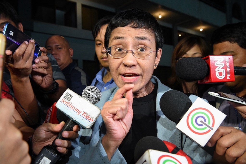 Journalist Maria Ressa speaking to the media as she arrives at the National Bureau of Investigation (NBI) headquarters after her arrest in Manila. The 2021 Nobel Peace Prize was awarded on 8 October 2021 to Ressa (Philippines) and Dmitry Muratov (Russia). (Ted Aljibe / AFP)
