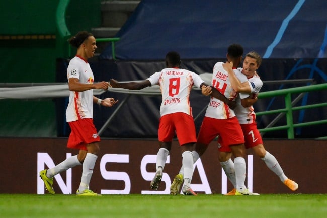 Tyler Adams of RB Leipzig celebrates with teammates after scoring his teams second goal during the UEFA Champions League Quarter Final match between RB Leipzig and Club Atletico de Madrid (Photo by Lluis Gene/Getty Images)
