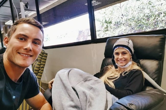 Dan supporting Candice during her first chemo session. She wore a cold cap to prevent her hair from falling out. (Photo: Instagram/Candice_Kriel)