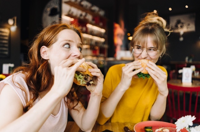 Women eating burgers