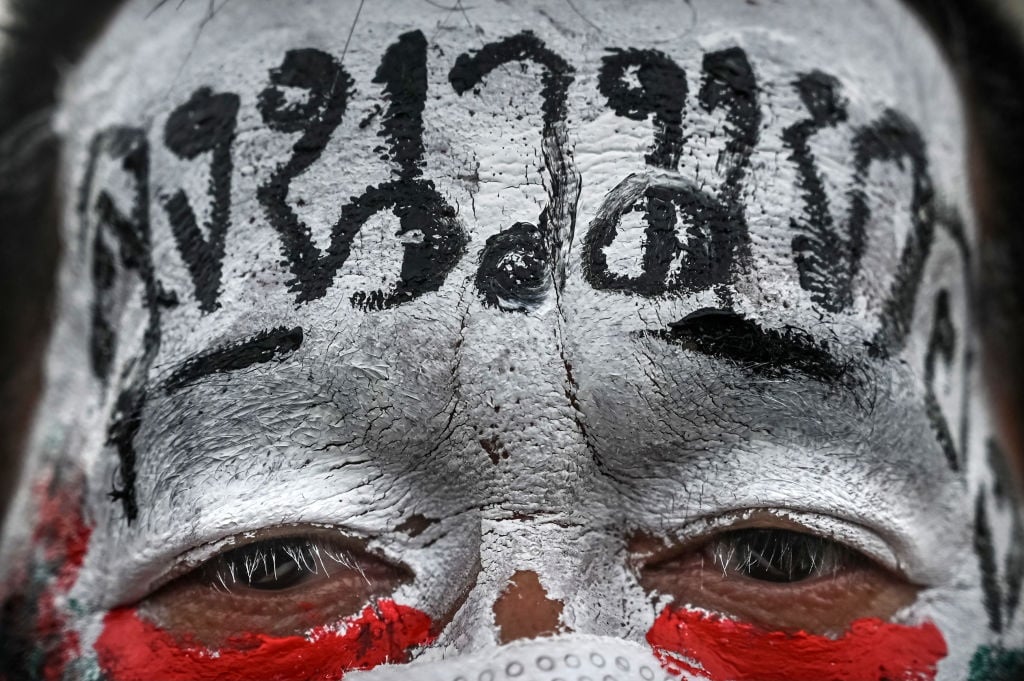 A protester with a political message painted on his face poses for a picture during a car mob rally in Bangkok, Thailand. (Photo by Sirachai Arunrugstichai/Getty Images)