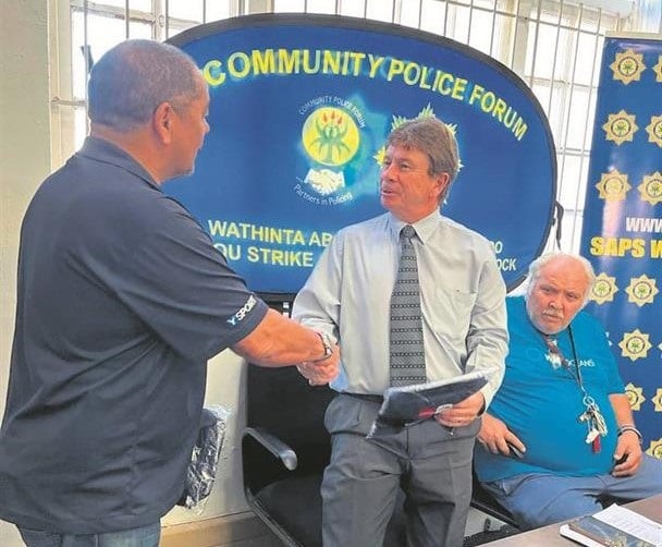 Sean Savage (CPF vice-chair) bids farewell to Lt Col Tian Lotz during a ceremony held recently. Seated is WO Marius Hattingh who will also be retiring after 40 years at the station.
