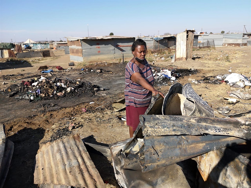 DiseboMtsokoba at her burnt down shack in Freedom Square, Mangaung. Photo by Kabelo Tlhabanelo.