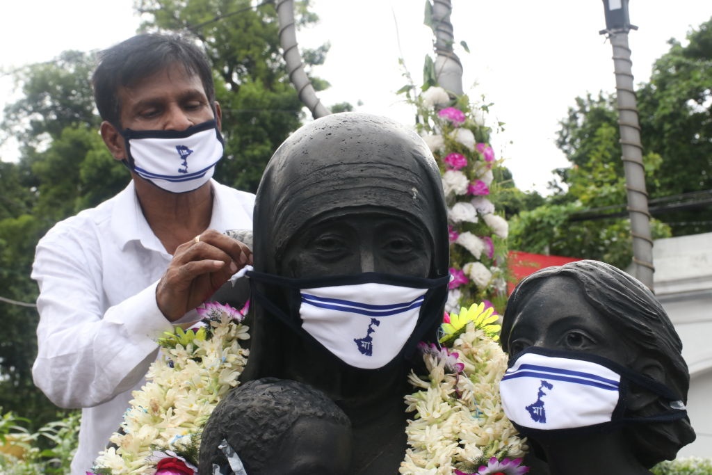 A view of the statue of Mother Teresa with a mask, during an event for celebrate the 110th birth anniversary of St. Teresa, in Kolkata, India.