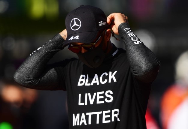 Lewis Hamilton walks on the grid wearing a 'Black Lives Matter' t-shirt prior to the F1 Grand Prix of Russia at Sochi Autodrom. Image: Mario Renzi / Getty