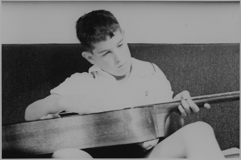 A young Johnny Clegg strings his guitar. (Supplied)