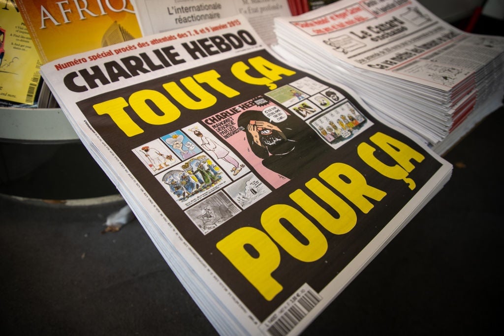 A close-up of covers of the french satirical weekly Charlie Hebdo reading "All of this, just for that" published on 2 September 2.