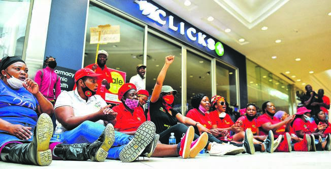 EFF members singing outside Clicks at Mall of Africa in Midrand.                                                    Photo by Christopher Moagi 