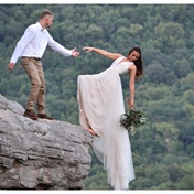 Couple capture daring wedding pictures on the edge of a cliff 