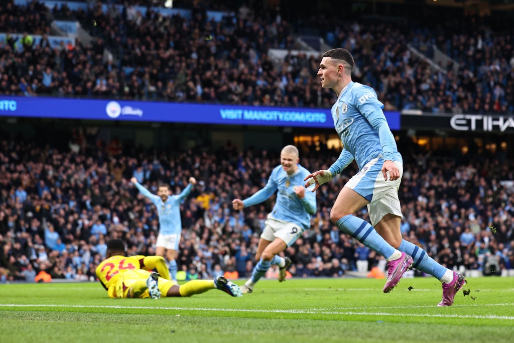 MANCHESTER, ENGLAND - MARCH 3: Phil Foden of Manchester City celebrates after scoring a goal to make it 2-1 during the Premier League match between Manchester City and Manchester United at Etihad Stadium on March 3, 2024 in Manchester, England. (Photo by Robbie Jay Barratt - AMA/Getty Images)