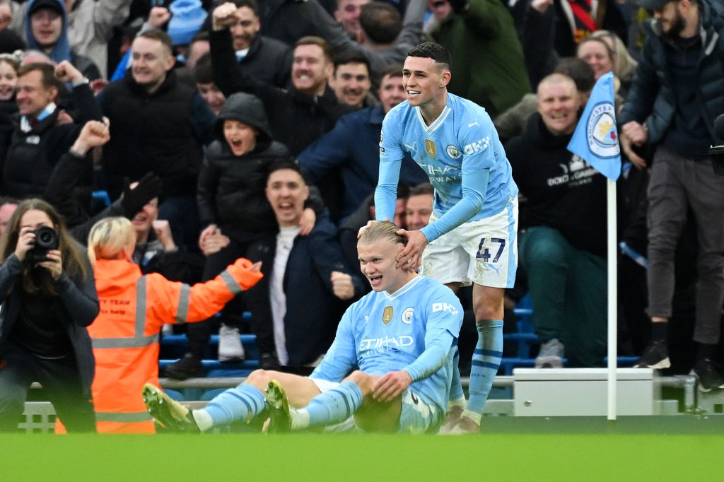 MANCHESTER, ENGLAND - MARCH 03: Erling Haaland of Manchester City celebrates with Phil Foden of Manchester City after scoring his teams third goal during the Premier League match between Manchester City and Manchester United at Etihad Stadium on March 03, 2024 in Manchester, England. (Photo by Michael Regan/Getty Images)
