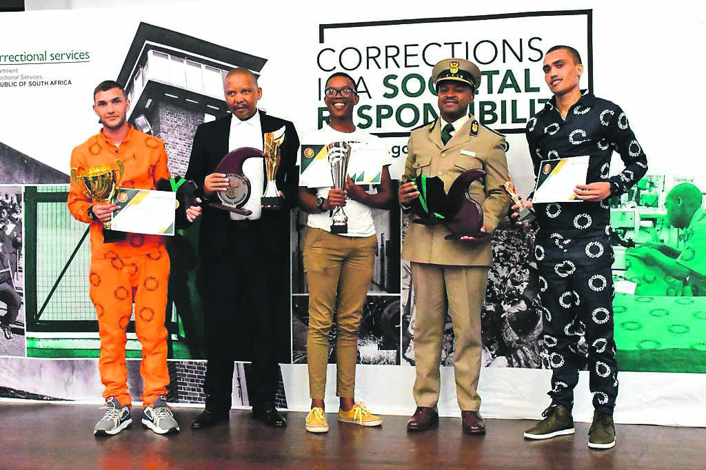 Best pupil in Correctional Services for the 2023 matric exams Mathew Benn, Correctional Services Deputy Minister Nkosi Holomisa, second-best pupil (now a parolee) Devon Jacobs and third-best pupil Nthuthuko Mshibe, at the awards ceremony in Durban Westville Correctional Centre