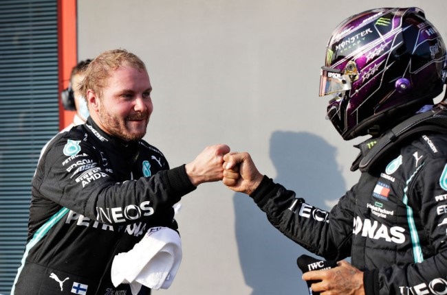 Pole position qualifier Valtteri Bottas and Mercedes GP bumps fists with second place qualifier Lewis Hamilton in parc ferme in parc ferme during qualifying ahead of the F1 Grand Prix of Emilia Romagna. (Photo by Luca Bruno - Pool/Getty Images)