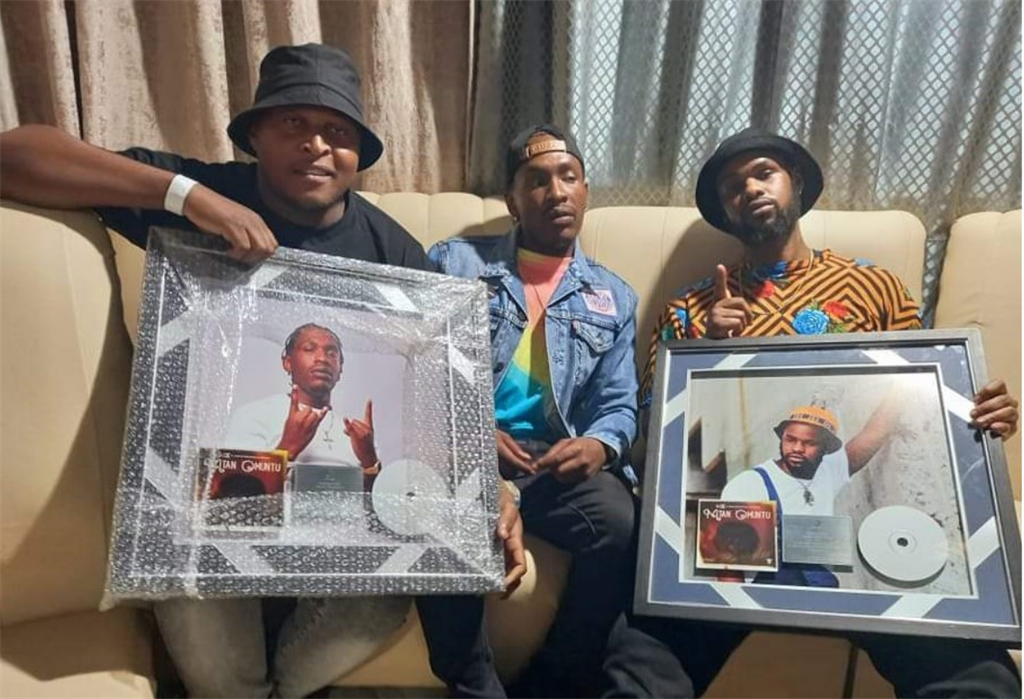 DJ N.E.P, Makwa Beats and Kid X holding their platinum plaques. 