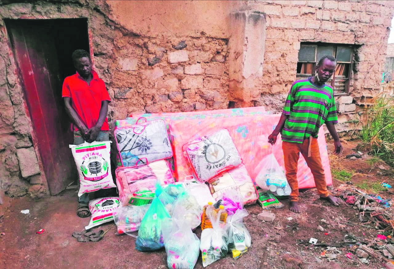 Brothers William and Simon Baloyi with food parcels and other goodies donated by the Department of Social Development.                                      Photo by Raymond Morare
