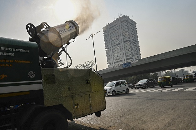An anti-smog gun operates along the road, hoping