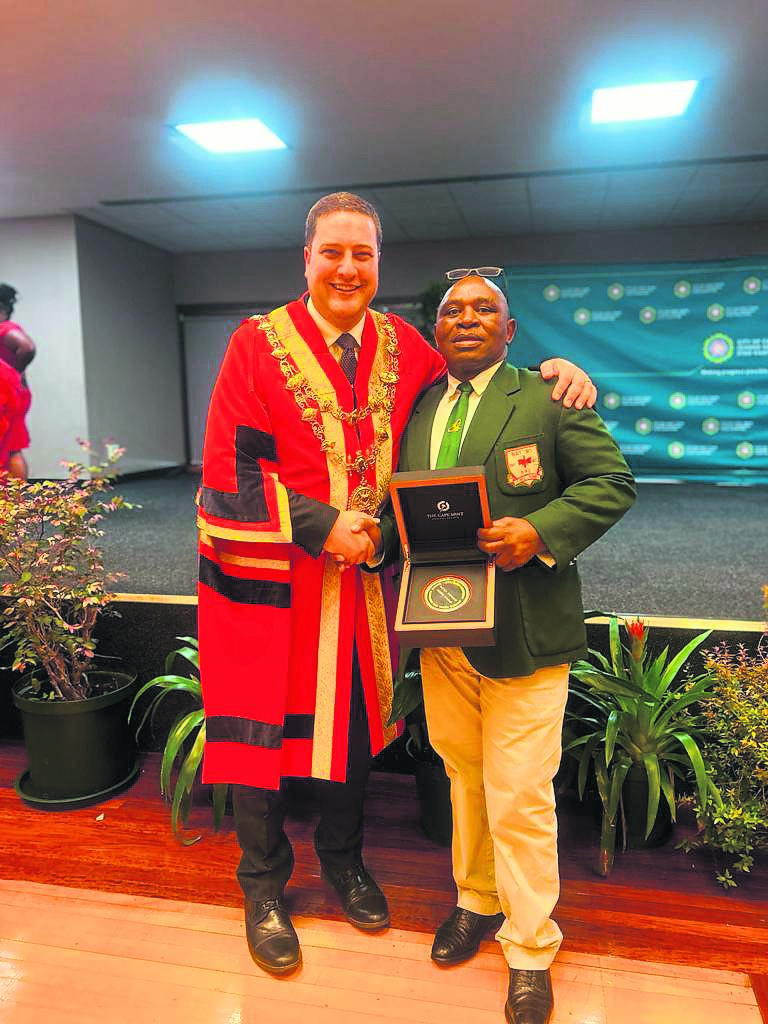 Director of Rugby at Busy Bee, Msutu Kewana receives the award from Mayor Geordin Hill-LewisPHOTO: SUPPLIED