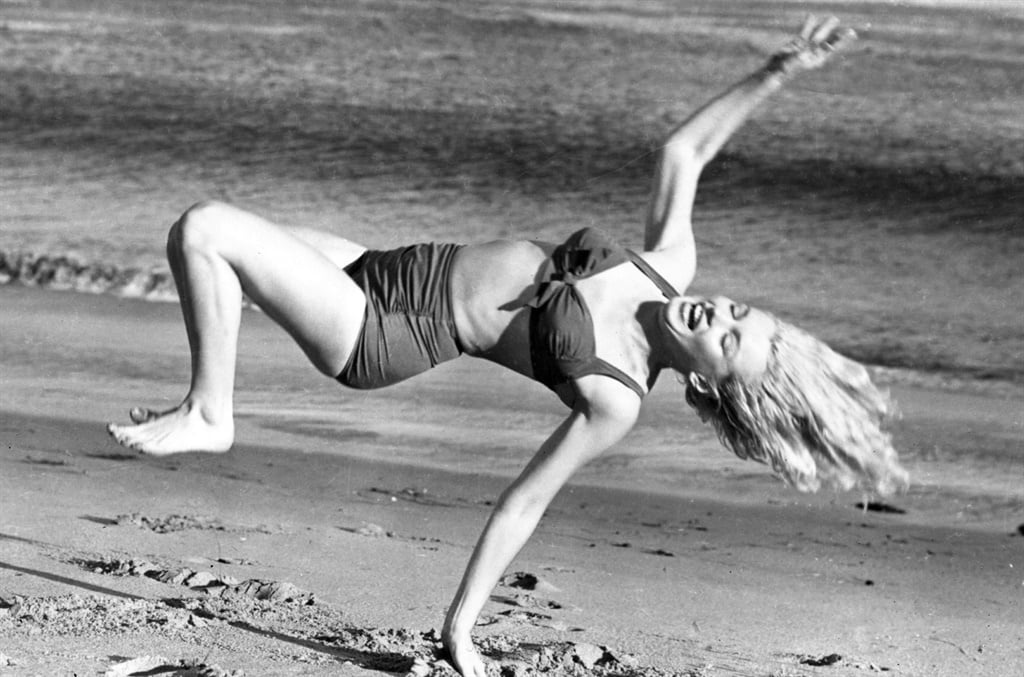 Marilyn Monroe - one of history's symbols of femininity - in a bikini in the '50s. This is a time when pubic hair became unwanted. (Photo by © Hulton-Deutsch Collection/CORBIS/Corbis via Getty Images)