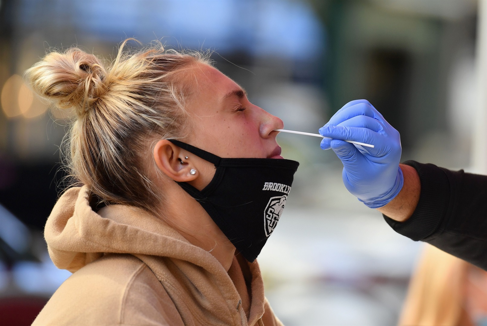 A medical worker tests a student for COVID-19 at a pop-up testing site in New York City on October 8, 2020.
