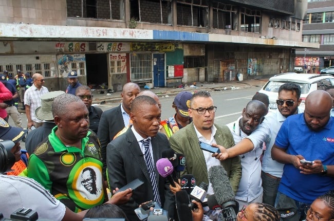 Joburg mayor Kabelo Gwamanda outside the hijacked Nugget Street which was set alight.