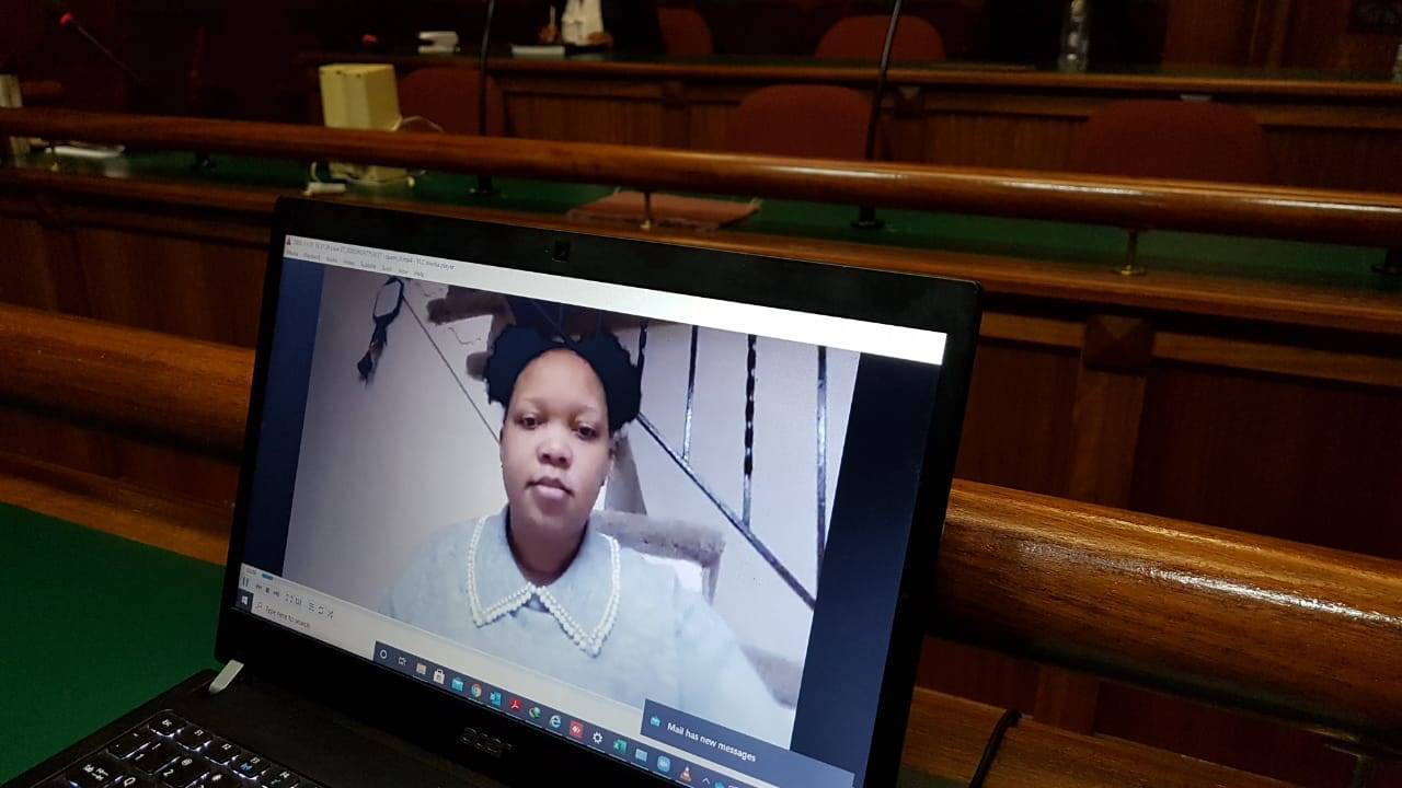 Moroadi Cholota testifying on camera. 