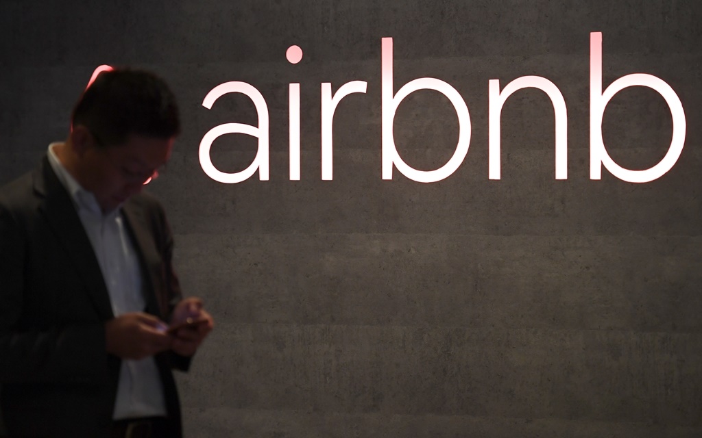 The US rental site Airbnb logo is displayed during the company's press conference in Tokyo.